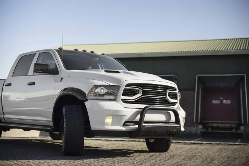 White pickup truck parked near industrial building
