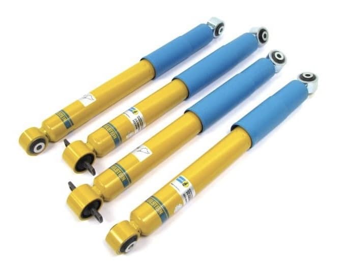 Set of four yellow and blue car shock absorbers